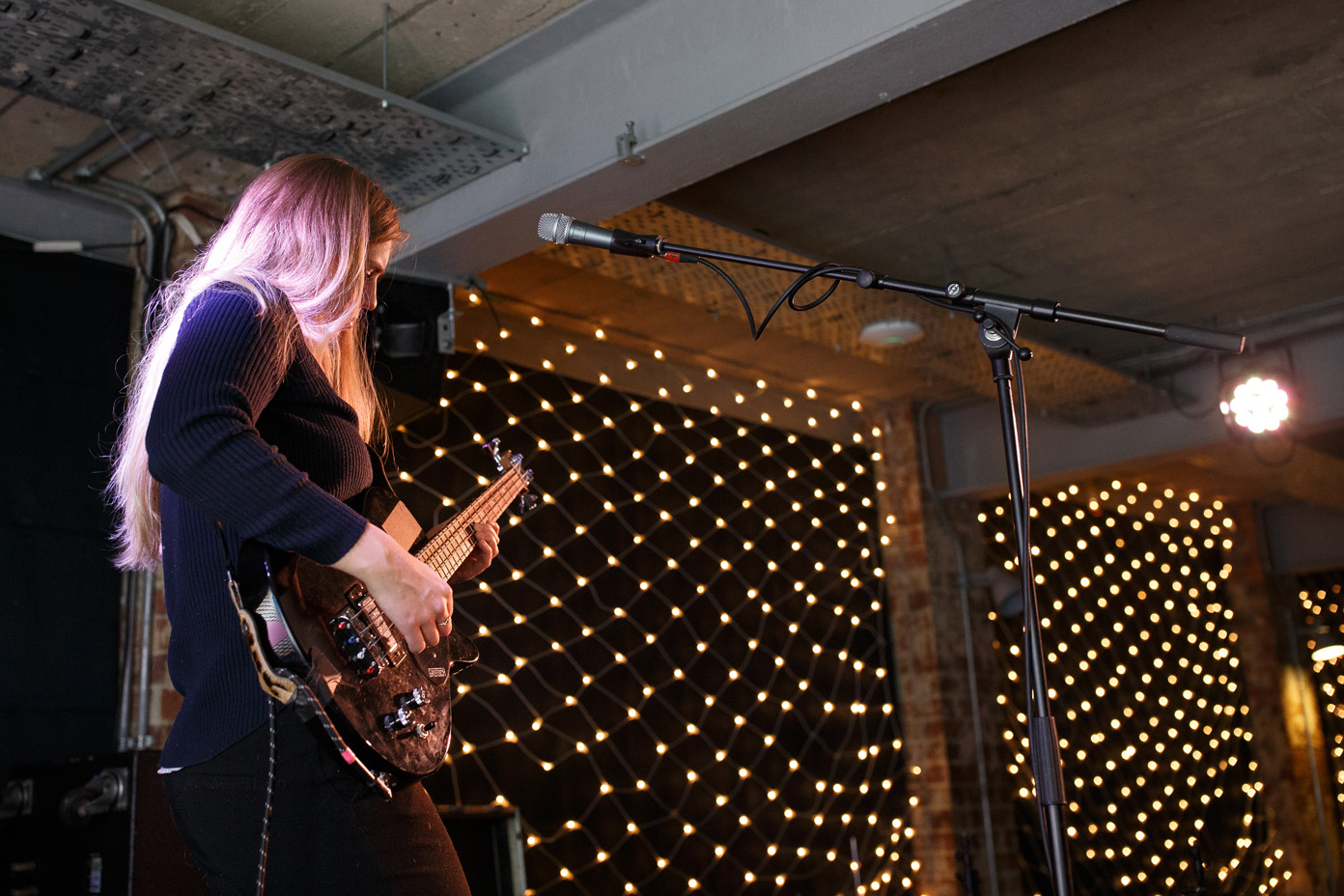 Signe SigneSigne illuminated by fairy lights as she soundchecks her other guitar